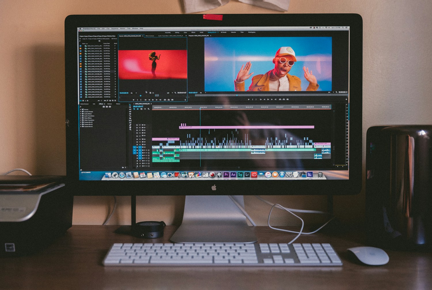 A video editing workstation with a film timeline on screen